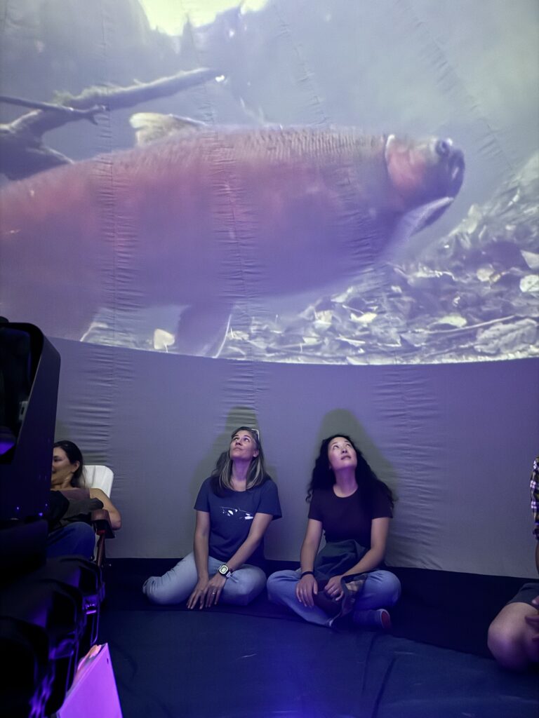 two females looking at fish in an aquarium