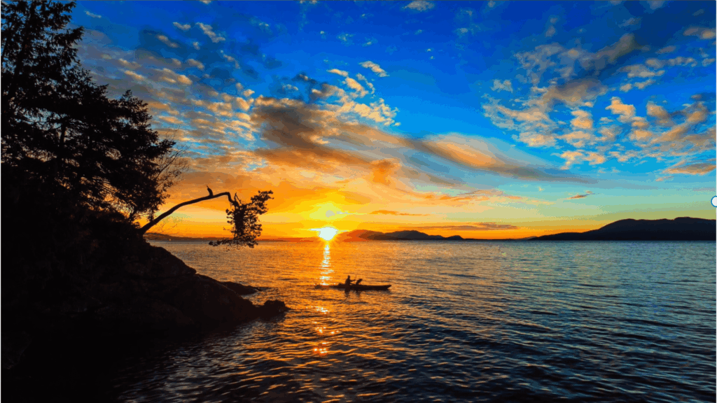 kayake in the middle of the ocean at sunset