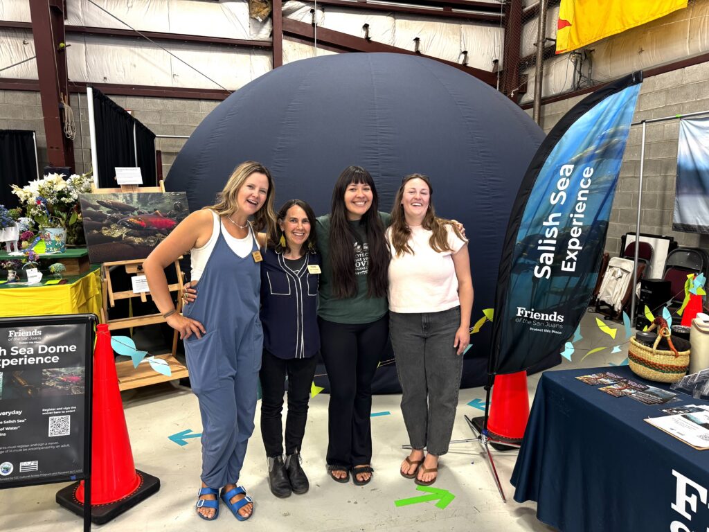 Friends staff members in front of the Salish Sea Dome.